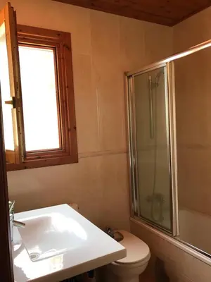 a bathroom with a toilet and a shower and a sink at Casa Mar y Piscina (solo familias) in Sant Cebrià de Vallalta