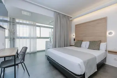 a hotel room with a bed and a desk and a table at Casa Lit Barcelona in Barcelona