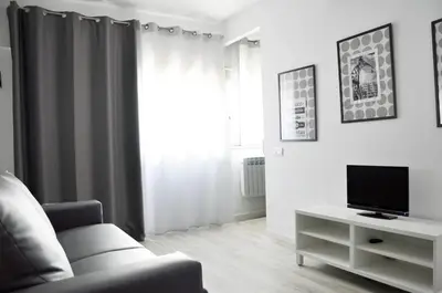 a living room with a couch and a tv at Residencia Universitaria Resa La Ciutadella in Barcelona