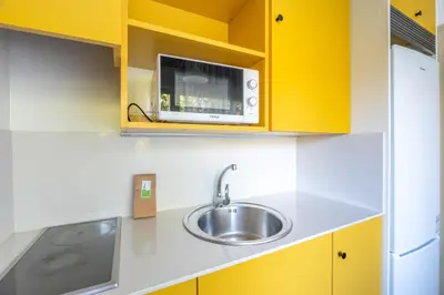 a kitchen with a sink and a microwave at Residencia Universitaria Resa La Ciutadella in Barcelona