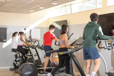a group of people exercising on treadmills in a gym at Residencia Universitaria Resa Campus del Mar in Barcelona