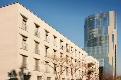 a building in front of a tall glass building at Residencia Universitaria Resa Campus del Mar in Barcelona