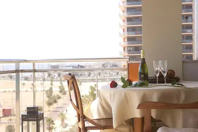 a table with a bottle of wine and a glass at Great Sea-Side Barcelona Apartment in Badalona