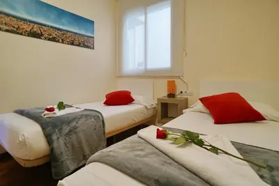 a room with two beds with roses on them at Barcelona4Seasons - Central Palace in Barcelona