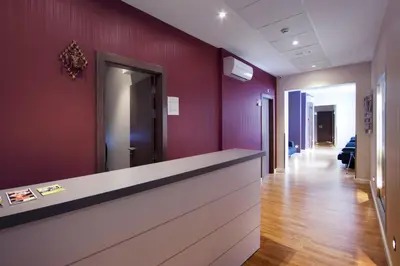 an office lobby with purple walls and a reception counter at Hostal BCN Ramblas in Barcelona