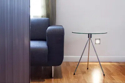 a blue chair sitting next to a glass table at Hostal BCN Ramblas in Barcelona