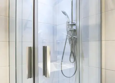 a shower with a shower head in a bathroom at Hostal BCN Ramblas in Barcelona