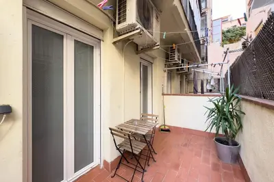 a balcony with a wooden bench and a window at ApartEasy - Central Gracia Apartments in Barcelona