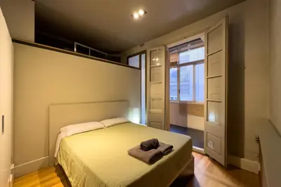 a bedroom with a bed with a towel on it at ApartEasy - Central Gracia Apartments in Barcelona