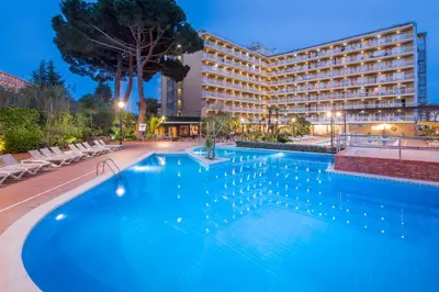 a large swimming pool in front of a hotel at Hotel President in Calella