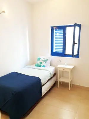 a small bedroom with a bed and a window at Love Sitges & Beach in Sitges