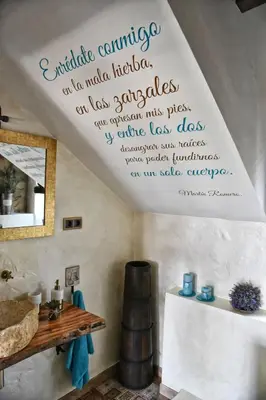 a room with a table and a sign on the ceiling at Cova Safaja in San Quírico Safaja