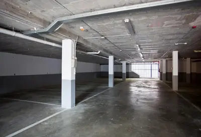 an empty parking lot with white poles in a room at SG Marina 54 Apartments in Castelldefels