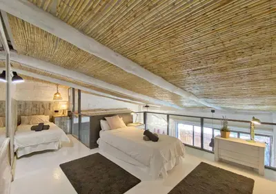 a bedroom with two beds and a wooden ceiling at Fridays Flats Casa Lavander in Barcelona