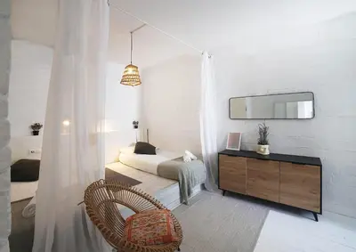a bedroom with a bed and a dresser and a mirror at Fridays Flats Casa Lavander in Barcelona