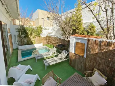 a backyard with a pool and chairs and a fence at Fridays Flats Casa Lavander in Barcelona