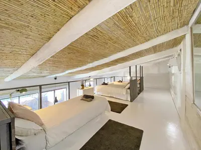 a bedroom with a large bed and a large ceiling at Fridays Flats Casa Lavander in Barcelona