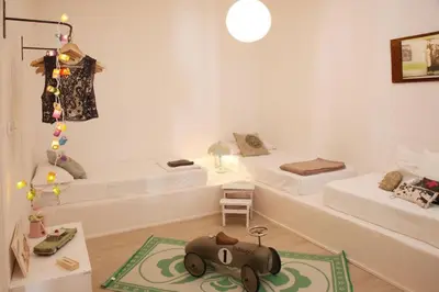 a room with two beds and a toy elephant on a rug at Fridays Flats Villa Alba in Barcelona