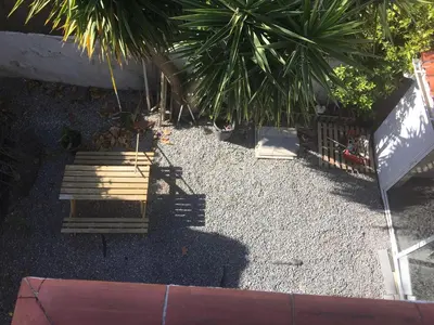 a group of benches sitting in a gravel yard at Villa Masnou Homelydays in El Carrer del Canonge