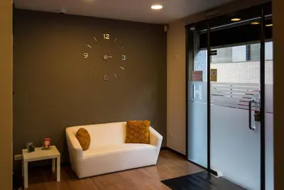 a living room with a clock on the wall at Hostal Sant Pau in Barcelona
