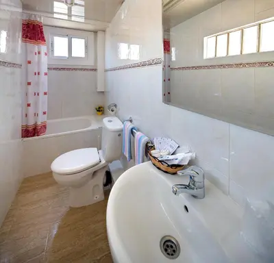 a white bathroom with a toilet and a sink at Hostal Barcelona in Barcelona