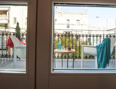 a window with a table and chairs on a balcony at Mosaic by Ona in Barcelona