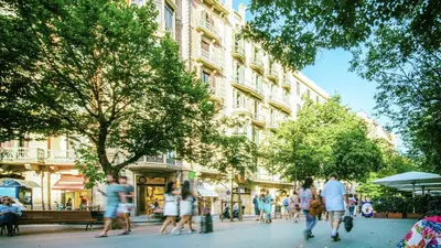 a group of people walking down a city street at Mosaic by Ona in Barcelona