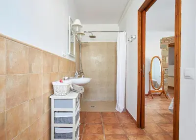 a bathroom with a sink and a shower at Rincón de piedra BCN in Corró de Vall