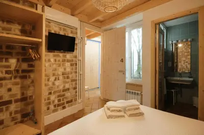 a bathroom with towels on a table in a room at B&B Sant Pol - Adults Only in San Pol de Mar