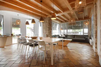 a kitchen and dining room with a table and chairs at B&B Sant Pol - Adults Only in San Pol de Mar