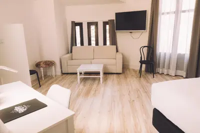 a living room with a couch and a tv at Hotelet Casa Padró in Manresa