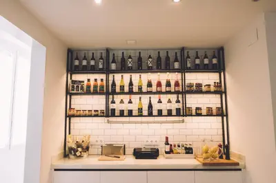 a shelf filled with bottles of wine on a wall at Hotelet Casa Padró in Manresa