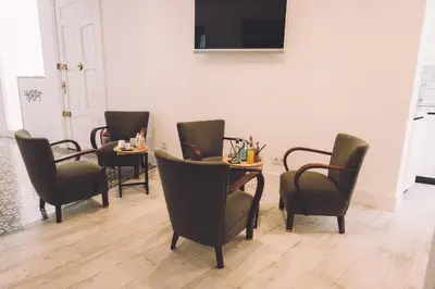 a meeting room with chairs and a table and a television at Hotelet Casa Padró in Manresa