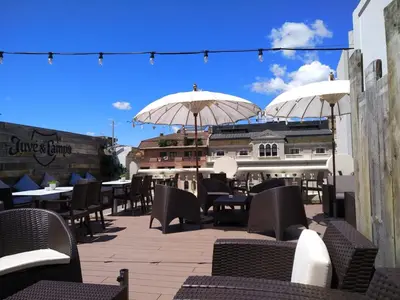 a patio with tables and chairs and umbrellas at Hotelet Casa Padró in Manresa
