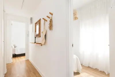 a living room with white walls and a window at WOW Apartments by Olala Homes in Hospitalet de Llobregat