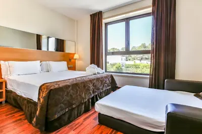 a hotel room with two beds and a window at Hotel Desitges in Sant Pere de Ribes