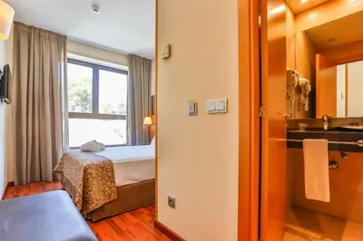 a hotel room with a bed and a bathroom at Hotel Desitges in Sant Pere de Ribes