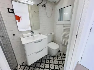 a small bathroom with a toilet and a sink at Rainbow Apartments BY BLAUSITGES in Sitges