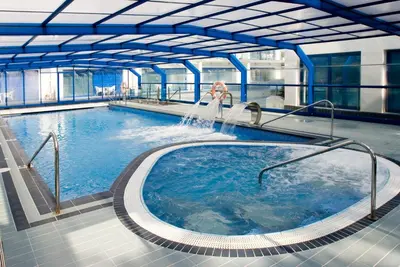 a large pool of water in a building at Masd Mediterraneo Hotel Apartamentos Spa in Castelldefels