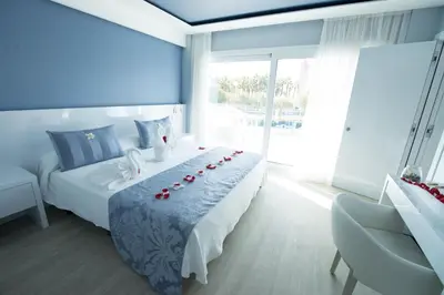 a bedroom with a bed with red roses on it at Masd Mediterraneo Hotel Apartamentos Spa in Castelldefels