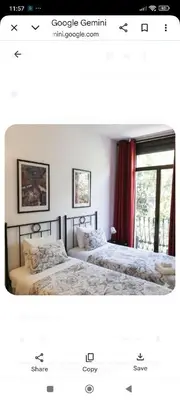 a bedroom with two beds and a window at Hostal Absolut Stay in Barcelona