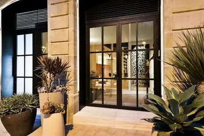 a lobby with potted plants in front of a door at Yurbban Passage Hotel & Spa in Barcelona