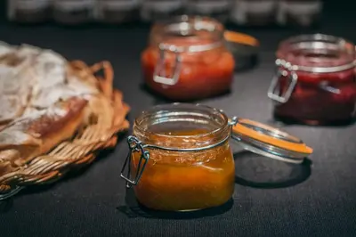 a jar of honey next to a basket of food at Yurbban Passage Hotel & Spa in Barcelona
