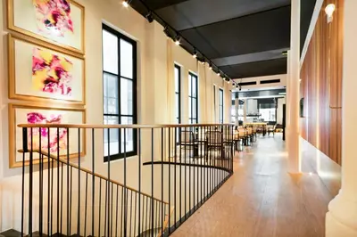 a hallway with tables and chairs in a building at Yurbban Passage Hotel & Spa in Barcelona
