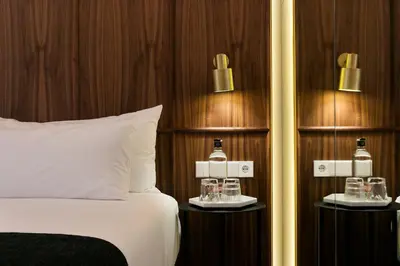a hotel room with a bed and two tables with bottles on it at Yurbban Passage Hotel & Spa in Barcelona