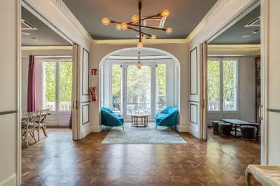 a hallway with an archway and a table and chairs at Casa Gracia in Barcelona