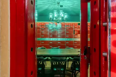 a dining room with a table and chairs and a chandelier at Casa Gracia in Barcelona