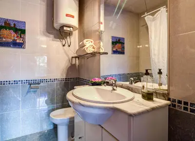 a bathroom with a sink and a toilet at Valencia Suite ArchsenseApartments in Barcelona