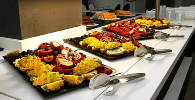a buffet with several trays of food on a table at Summer Hotel in Calella
