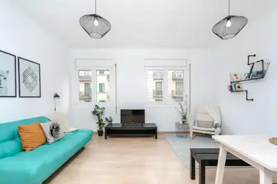 a living room with a blue couch and a table at Centric Apartments Paseo de Gracia in Barcelona